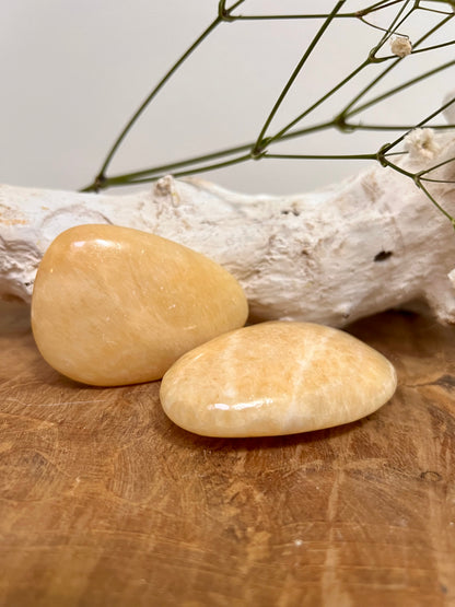 Orange calcite palm stone